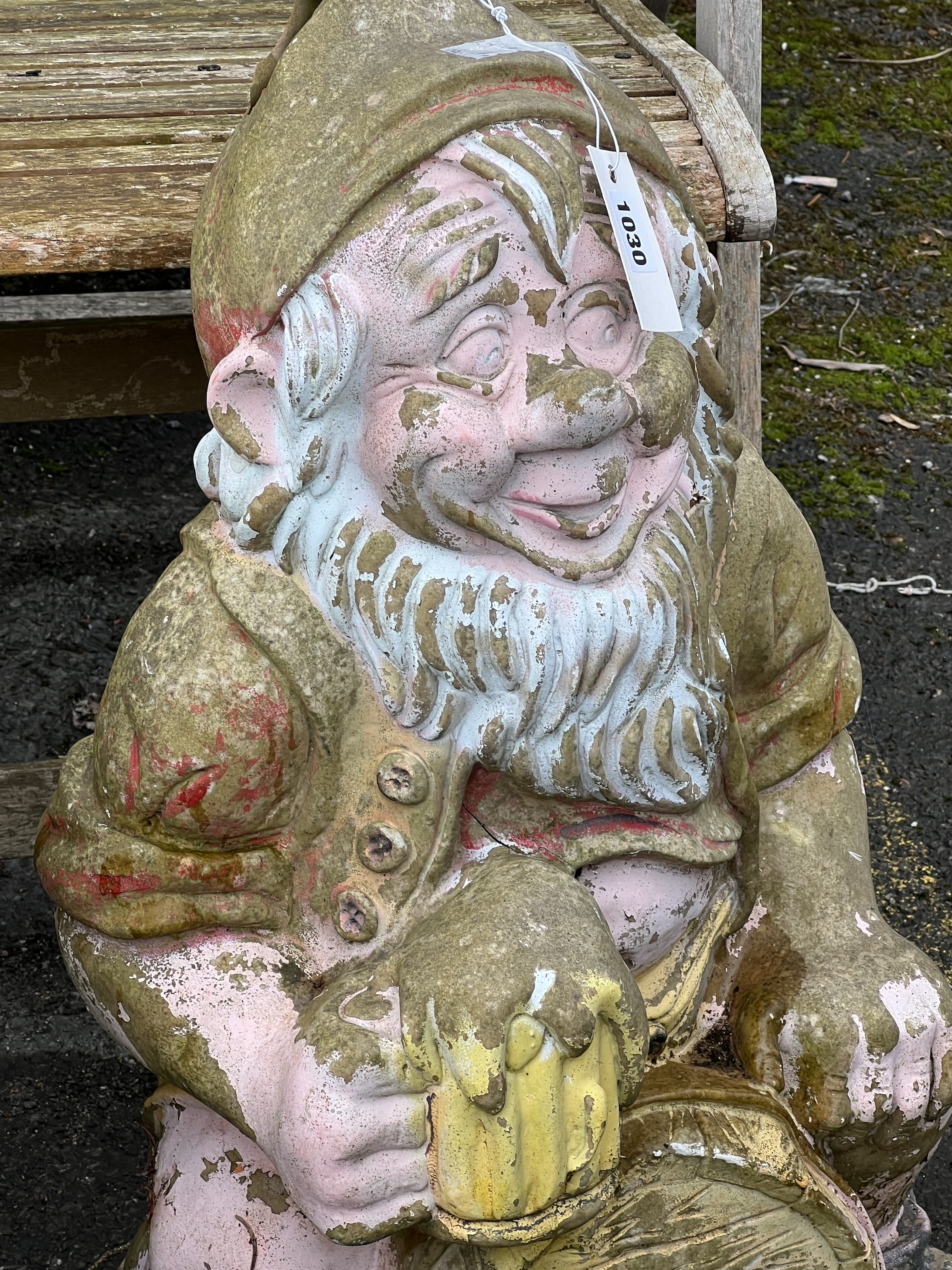 Two reconstituted stone and fibreglass gnome garden ornaments, larger height 65cm together with a seated pig garden ornament